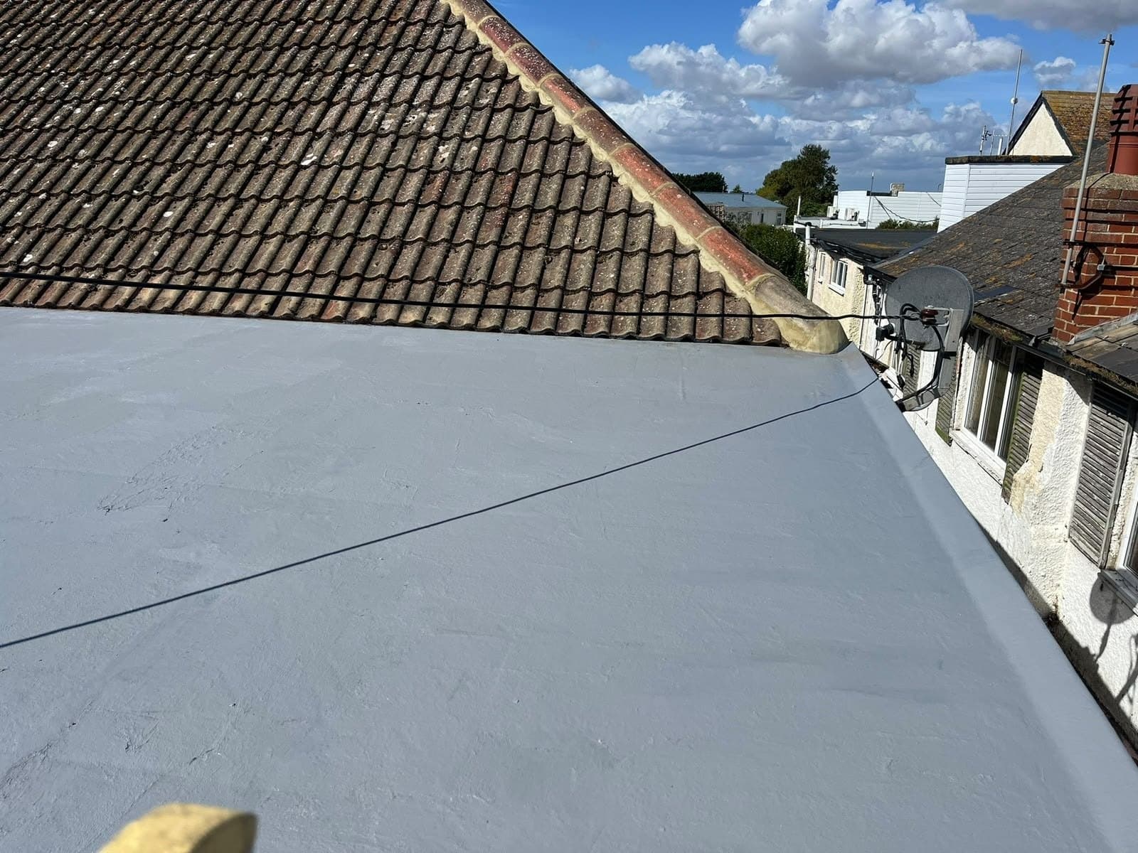 New fibreglass flat roof beside a tiled slope